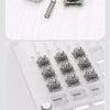A collection of gray mechanical keyboard switches and a spring shown on a white background.