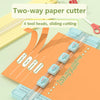 A two-way paper cutter tool with four sliding cutting heads demonstrating straight line, curve, dotted line, and indentation 