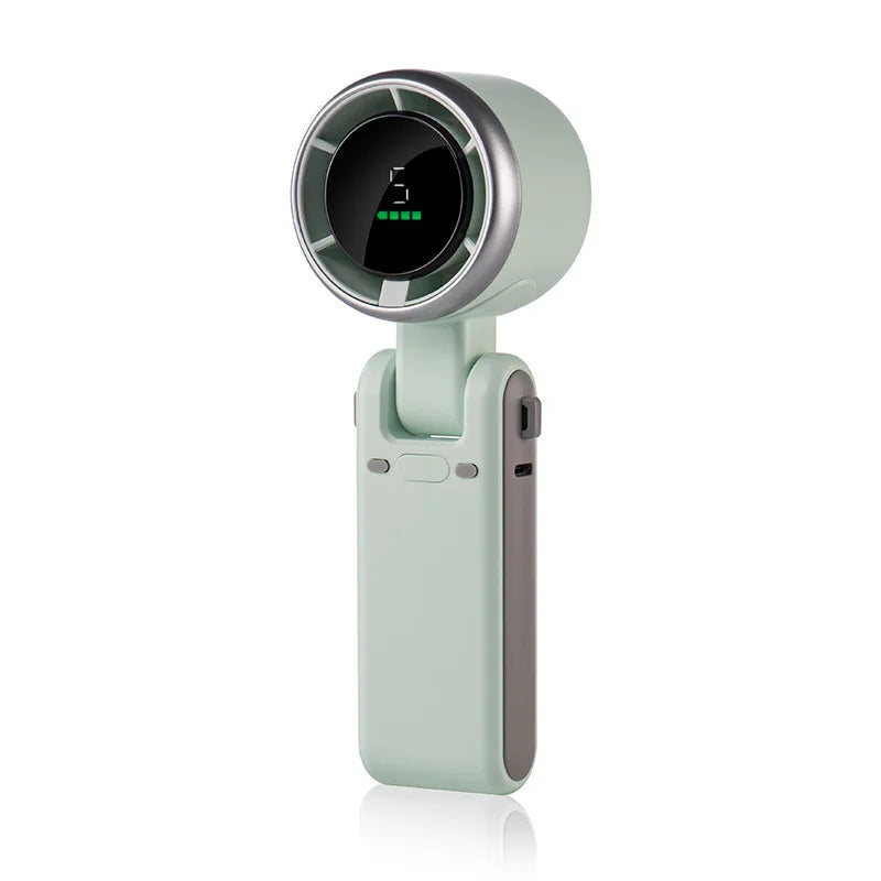 A portable handheld turbo fan in a light green color with a circular display and USB-C charging port.