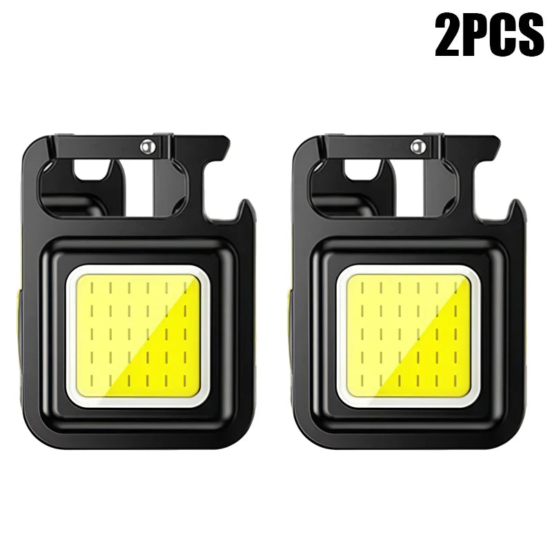 Two compact COB keychain flashlights with magnetic bases and rechargeable batteries.