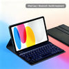An iPad case with a detachable Bluetooth backlit keyboard shown open on a laptop surface.