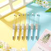Five pearl beaded ballpoint pens displayed on a light blue and yellow background with white flowers.