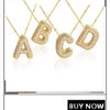 A set of gold-plated shell pearl beaded necklaces spelling out the letters A through D