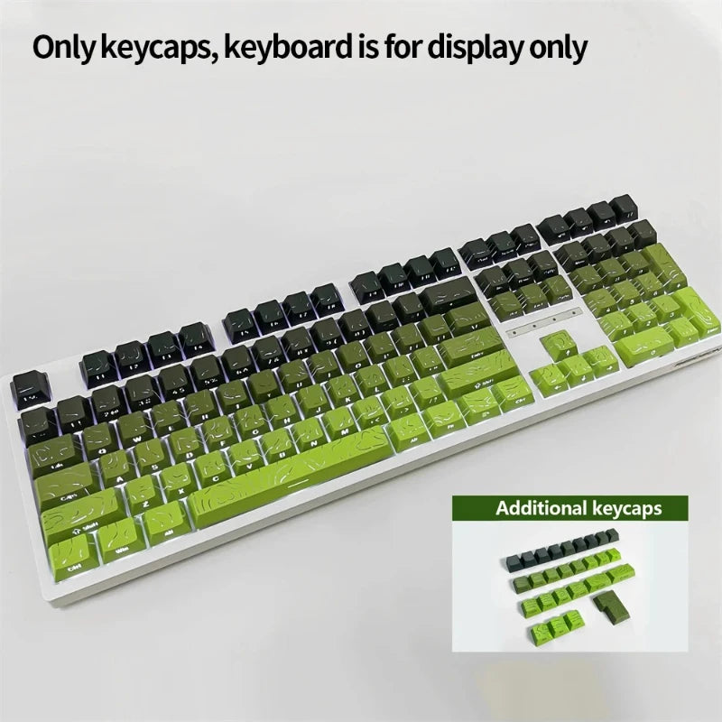 A close-up view of a white keyboard featuring green and black keycaps, with additional keycaps displayed below.