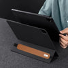 A black leather protective case is shown with a tablet and stylus inside, resting on a dark surface.
