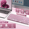 A pink transparent wireless mechanical keyboard is displayed next to a laptop and various electronic devices.