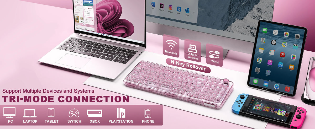 A pink transparent wireless mechanical keyboard is displayed next to a laptop and various electronic devices.