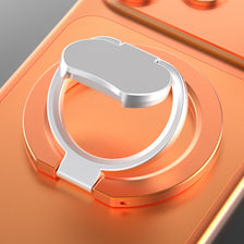 A silver magnetic phone stand with a kickstand is shown on an orange background.