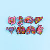 A collection of colorful enamel pins depicting various human organs and anatomy for medical professionals