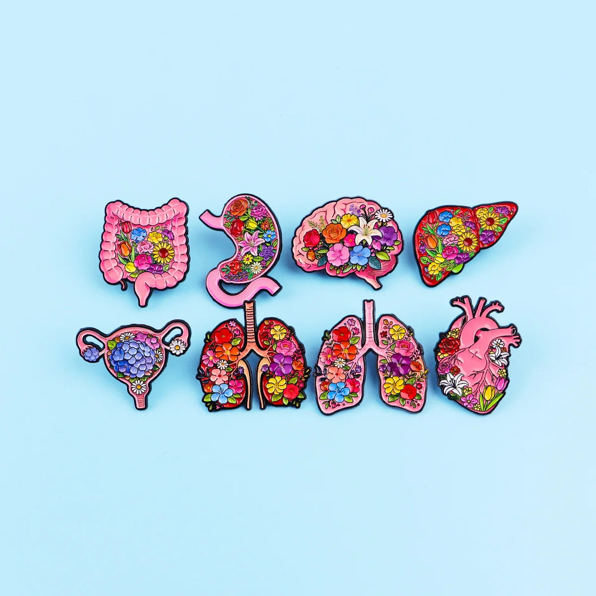 A collection of colorful enamel pins depicting various human organs and anatomy for medical professionals