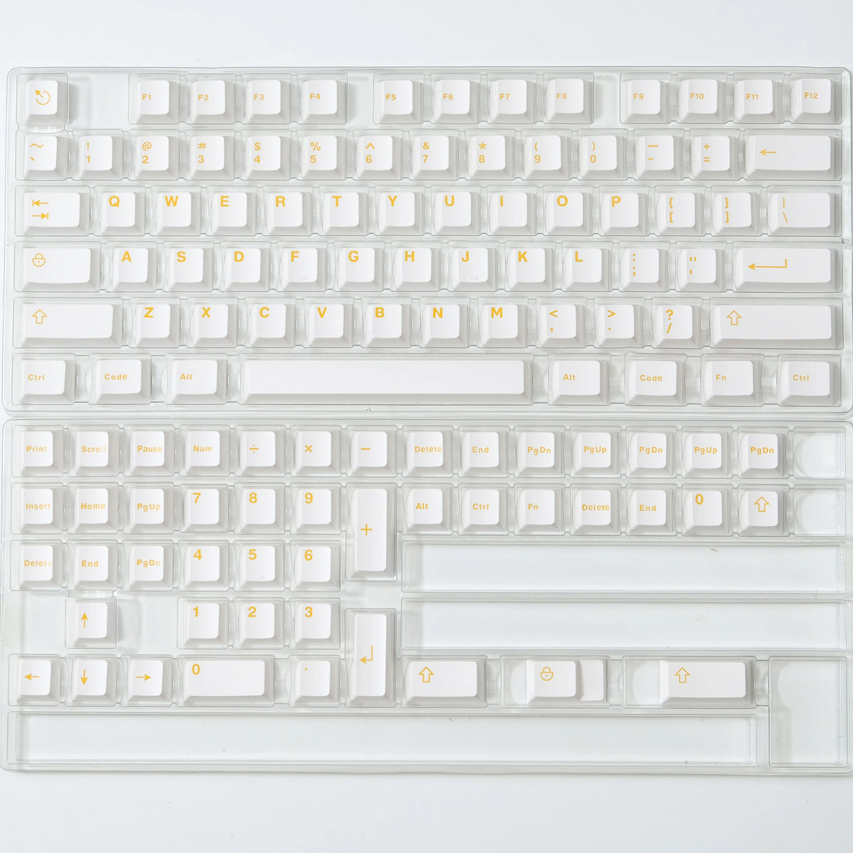 A close-up view of a clear acrylic mechanical keyboard featuring dark blue PBT keycaps and cherry profile switches.
