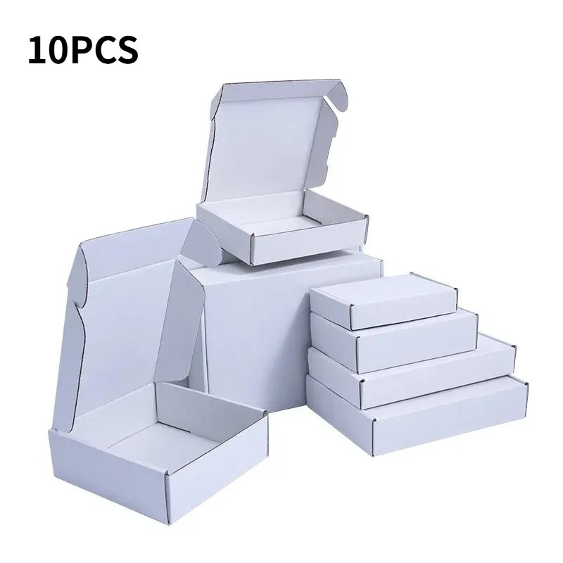 A set of ten white eco-friendly kraft gift boxes stacked and displayed.