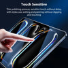 A hand touches a smartphone screen displaying colorful light effects and text, demonstrating touch sensitivity.
