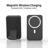 A black portable magnetic wireless charging power bank with a circular indicator light.