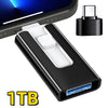 A black 1TB USB 3.0 flash drive with Lightning and Type-C connectors shown next to a smartphone.