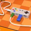 A beige 4-in-1 USB hub with Type-C ports and a white cable is shown on an orange checkered surface.