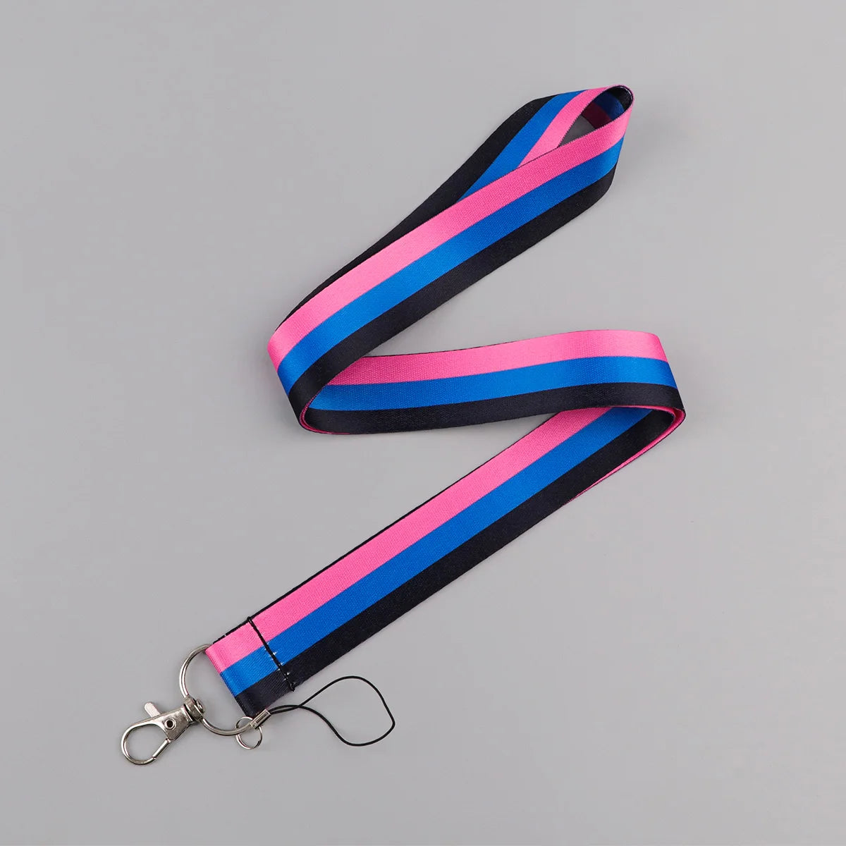 A striped lanyard featuring pink, blue, and black fabric, with a metal clip attached.