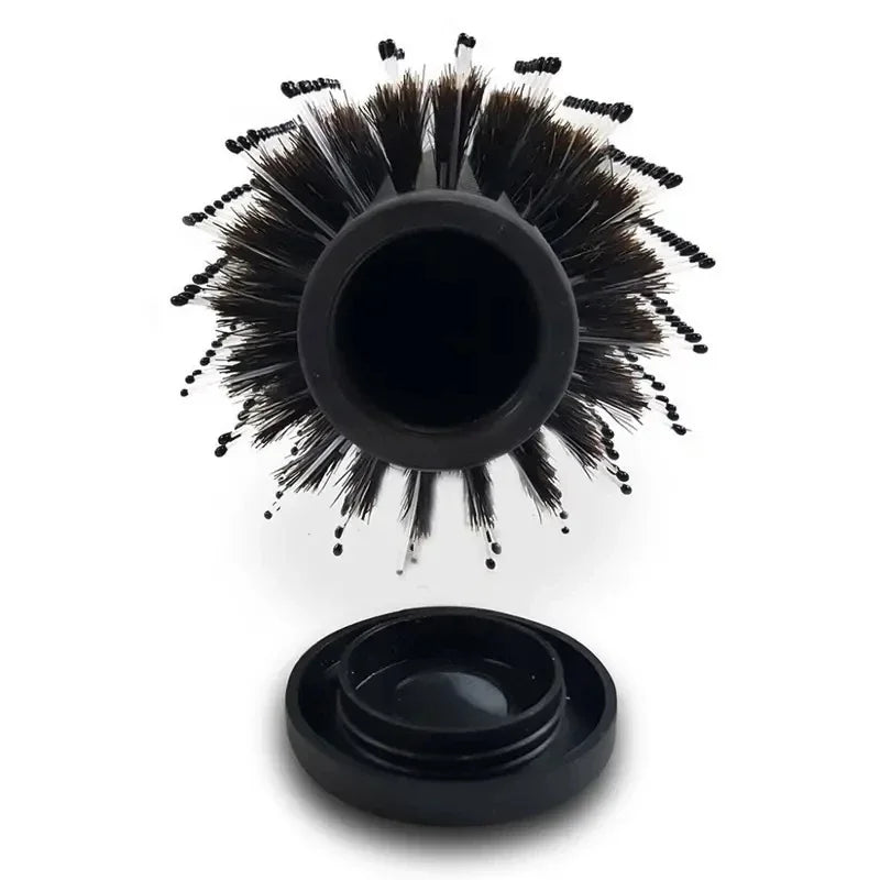 A black hair brush with a hidden compartment for storage.