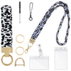 A black and white cow print stretchy lanyard with a gold clip and retractable reel for an ID badge.