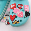 A light blue shoe features several heart-shaped and text charm decorations for a personalized gift set.