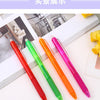 A set of eight colored retractable erasable gel pens in red, green, orange, and pink lying on a white surface.