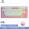 A pink mechanical keyboard with a light green backlight and a gasket mount design.