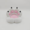 A white, soft cat paw shaped phone stand with pink accents and an anti-slip base.