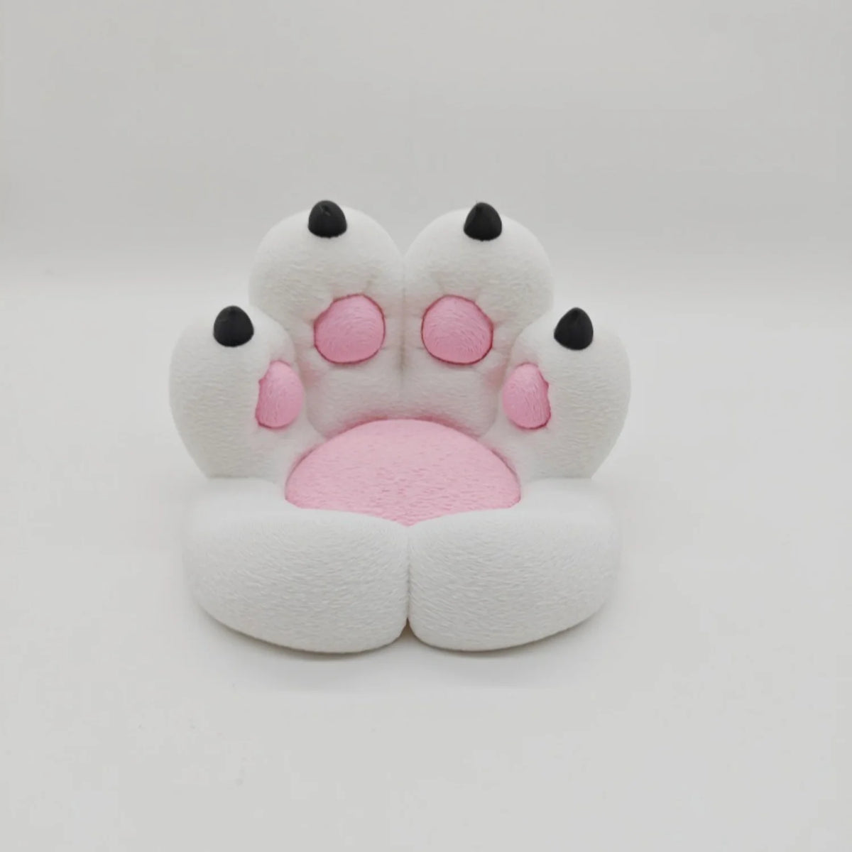 A white, soft cat paw shaped phone stand with pink accents and an anti-slip base.