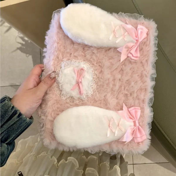 A pink fluffy rabbit plush case designed to hold an iPad, featuring white and pink accents.