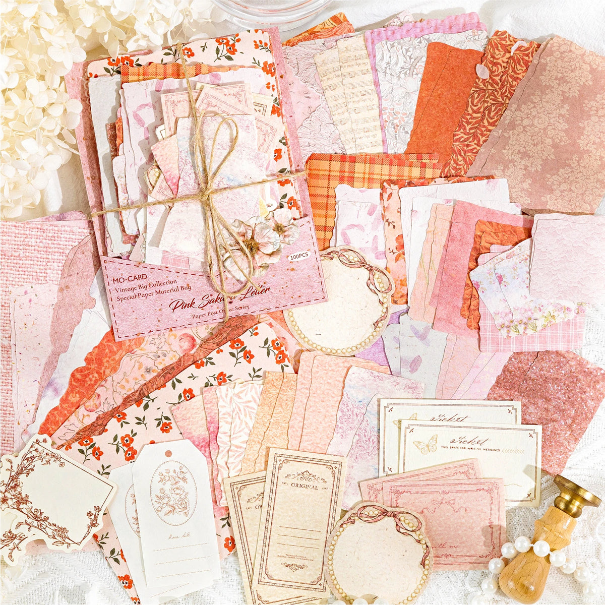 A collection of vintage pink and orange paper sheets for crafting, scrapbooking, and journaling.