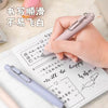 A hand holds a light purple Uni-Ball One Mini Cute Gel Pen writing on a spiral notebook.