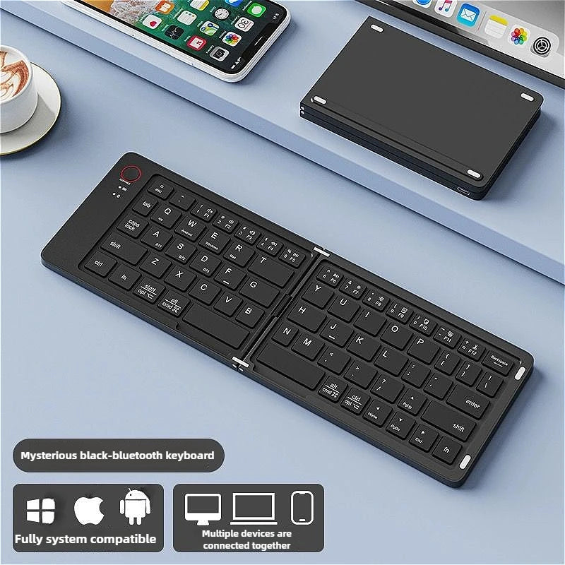 A black foldable Bluetooth keyboard is shown on a light blue surface next to a smartphone and a tablet.