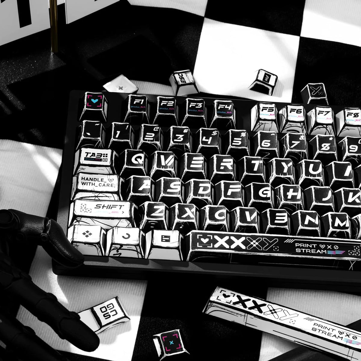 A close-up view of a black and white comic-style PBT keycap set on a keyboard, with various keycaps and accessories scattered