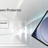 A close-up view of a tablet screen with a clear glass protector applied, displayed in a modern indoor setting.