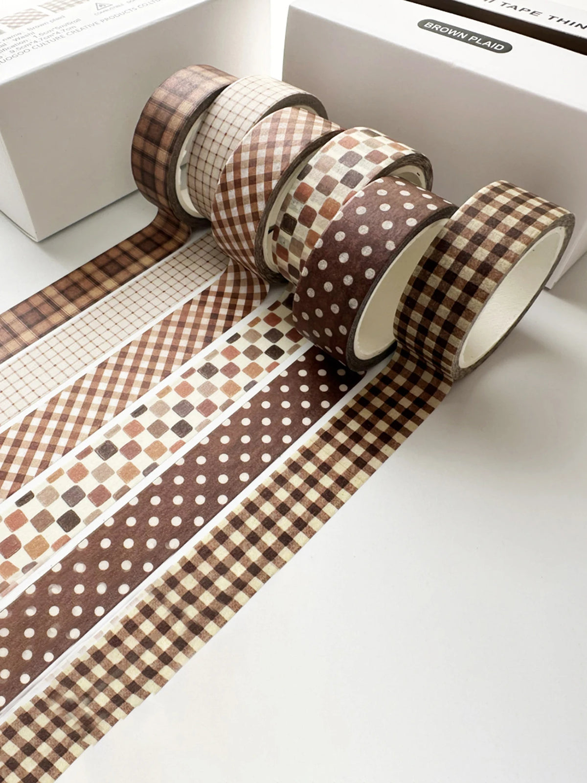 A set of six rolls of brown plaid washi tape featuring decorative grid and polka dot patterns for crafting.