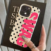 A hand holds a pink polka dot phone case with the word SWAG printed on it, displayed against a dark background.