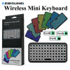 A set of colorful wireless mini keyboards and a full-size black keyboard are displayed in a box.