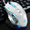 A white and blue computer mouse is shown resting on a black keyboard surface.