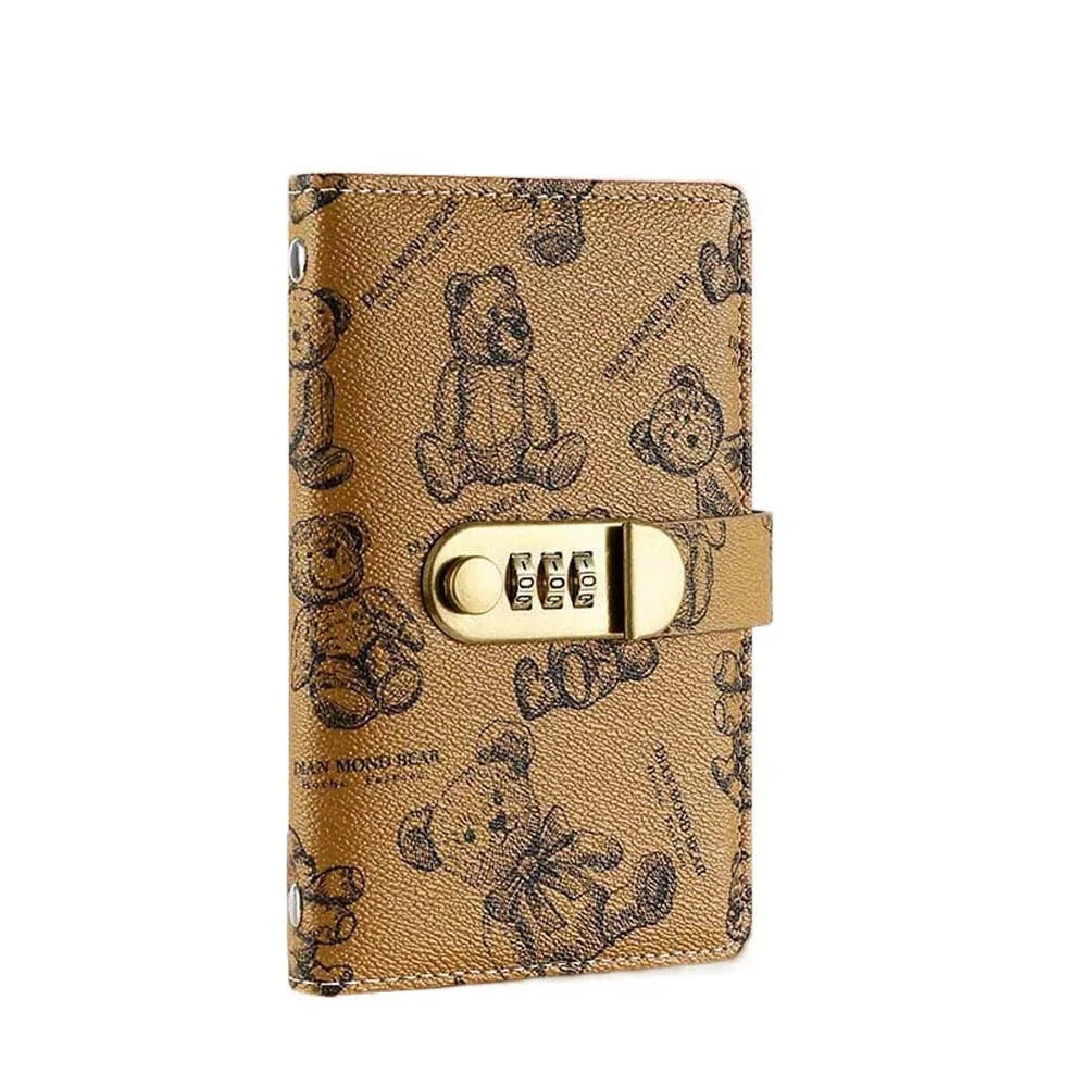 A gold patterned notebook cover featuring cute cartoon bears and a gold metal clasp.