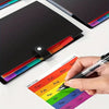 A hand is writing on a colorful index sticker sheet next to a black document organizer bag.