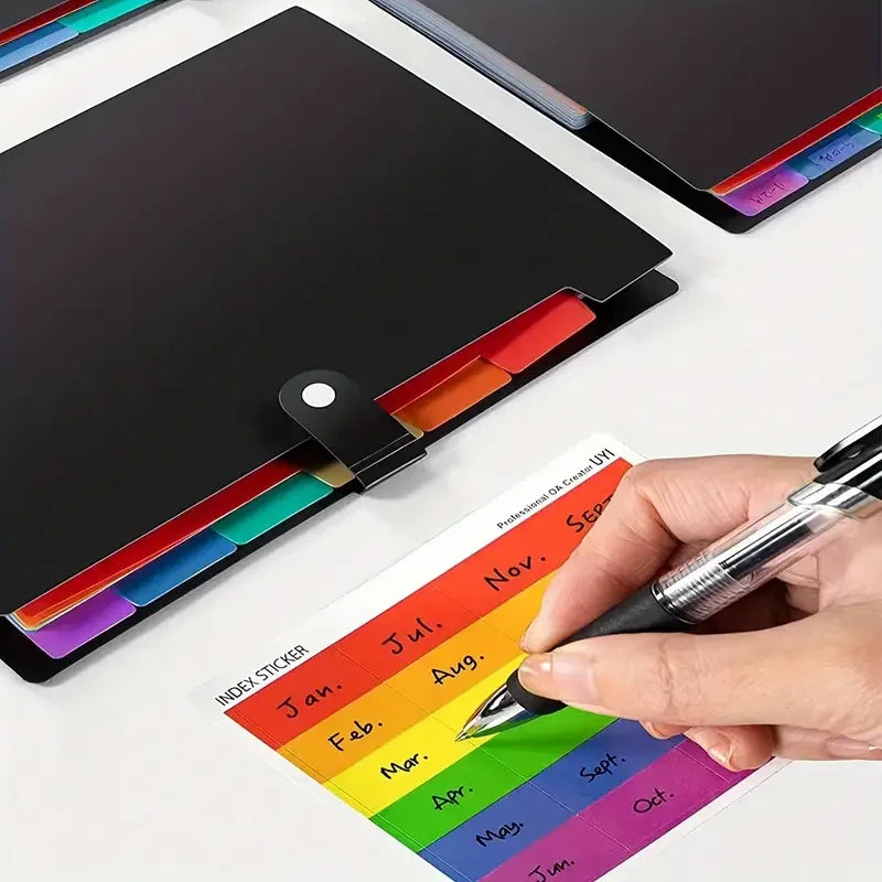 A hand is writing on a colorful index sticker sheet next to a black document organizer bag.