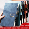 A stack of colorful notebooks with a blue cover and a pen insert shown next to a hand.