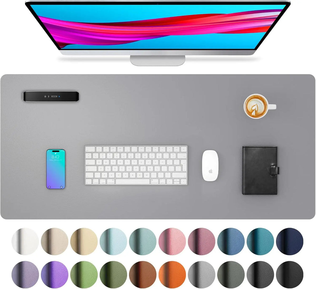 A large PU leather desk mat is shown with a laptop, keyboard, mouse, and a cup on a gray desk surface.
