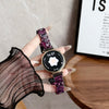 A hand holds a purple resin beaded watch with a black face and a dark purple strap, displaying the time 14:37.