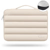 A beige protective laptop sleeve bag featuring quilted padding and a carrying loop.