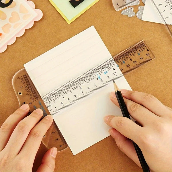 Hands are using a black pen to write on a piece of paper measured by an acrylic T-square ruler set.