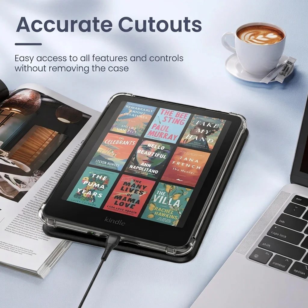 A black Kindle Paperwhite tablet with a clear case is shown next to a cup of coffee and a laptop.