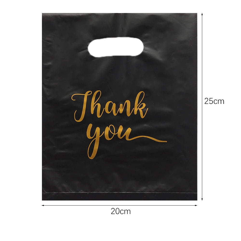Black gift bag with gold script text that reads Thank you
