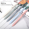 A collection of fine point gel pens in various colors, including black, gray, blue, and pink, shown on a white background.