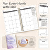 A planner showing a monthly calendar layout, a mini reference calendar, and notes space, with a purple marble design.
